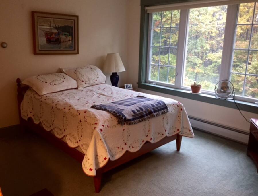 Spacious bedroom overlooking back woods.