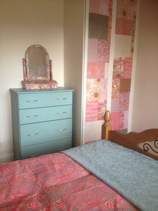 Double bedroom with chest of drawers and wardrobe