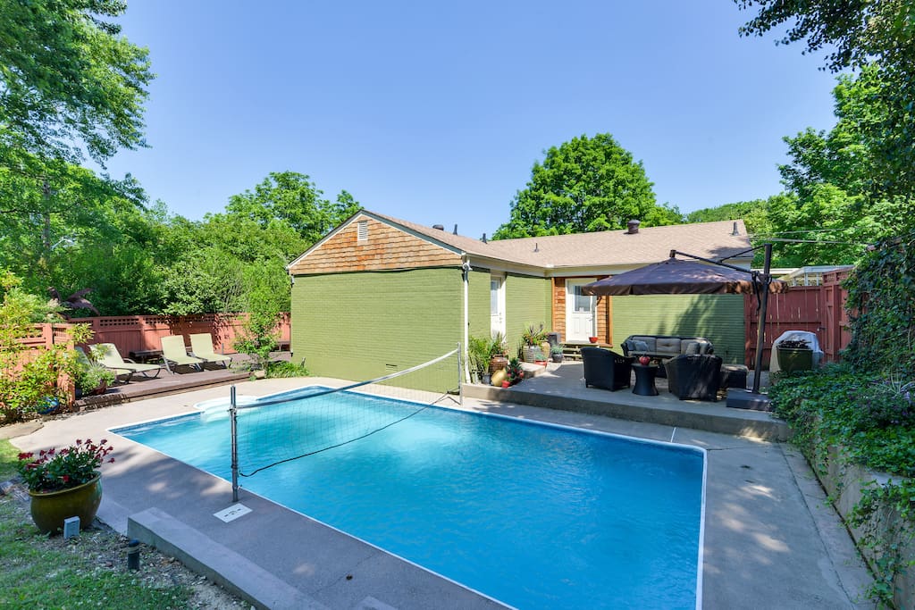 This backyard is incredible—there's a pool plus two separate furnished areas for relaxing and conversing.