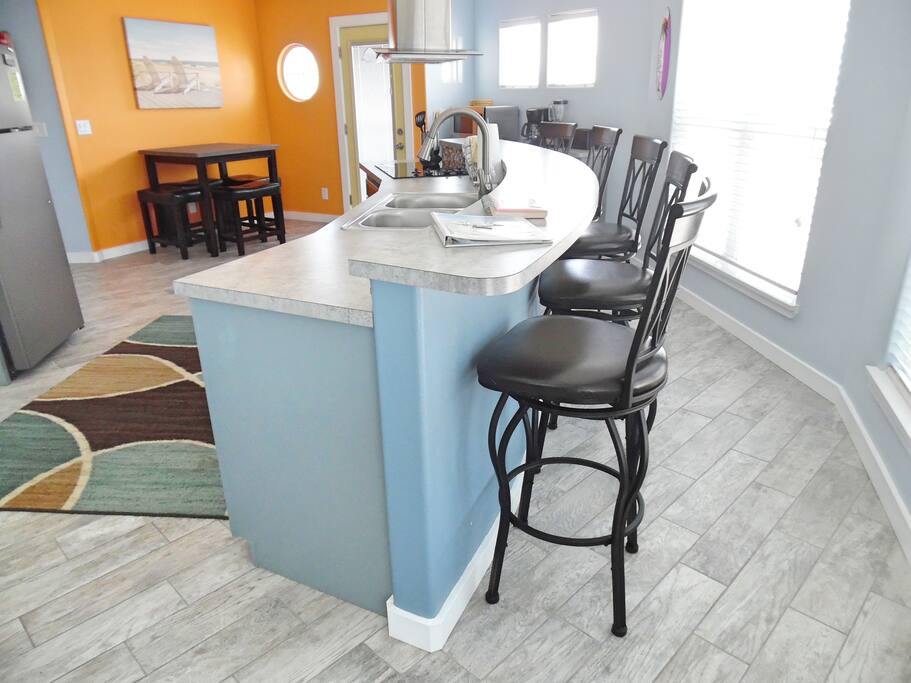 Entrance to Maui East with curved bar and kitchen prep area