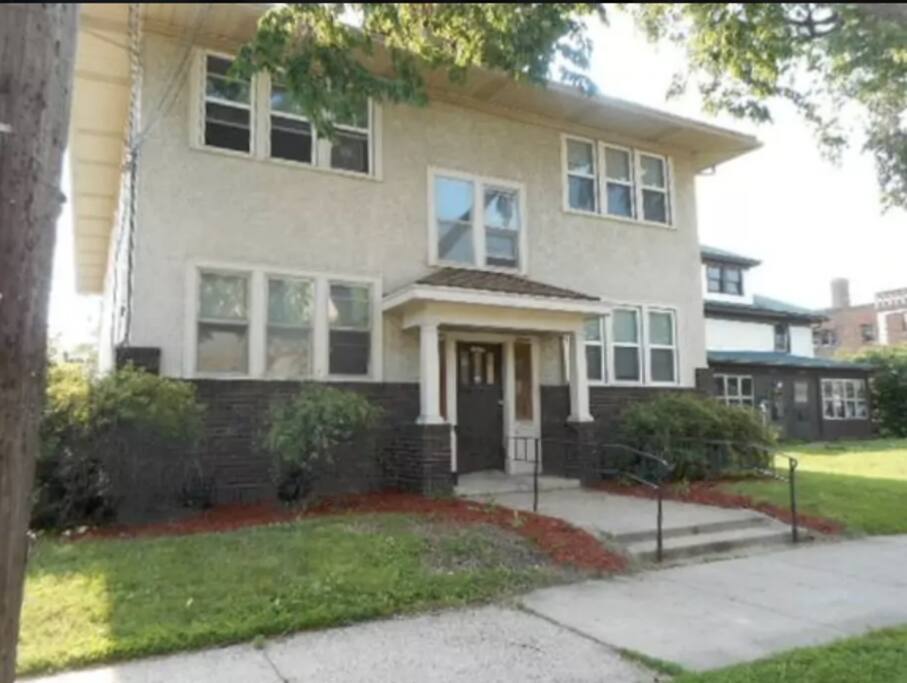 Classic stucco and brick exterior with secure front entry