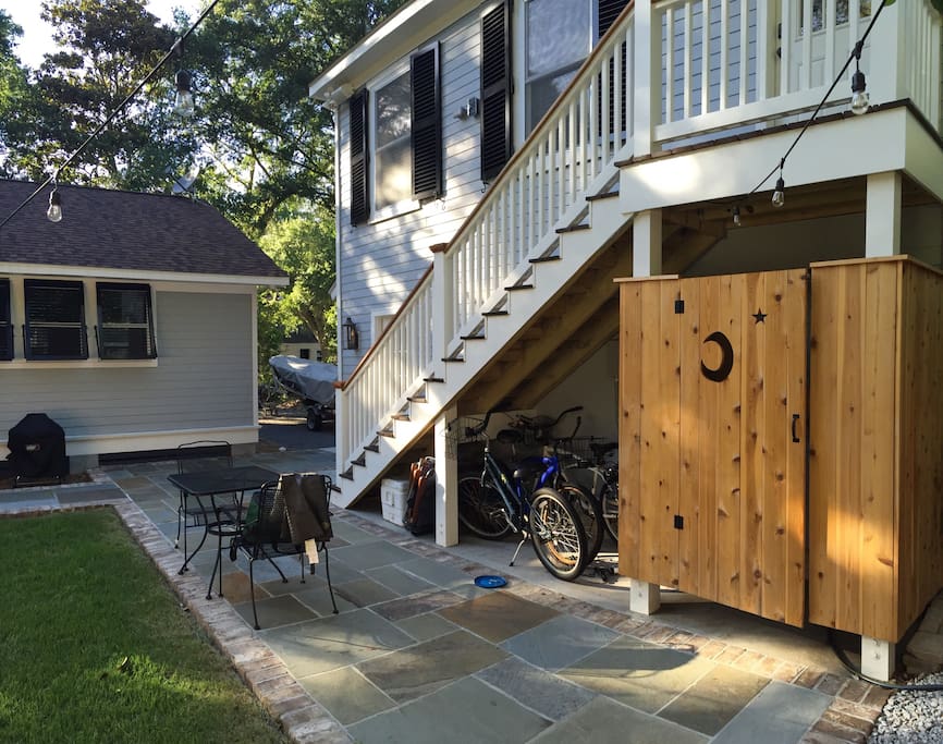 Outdoor shower, patio with outdoor seating, & bicycles to ride under the stairs!