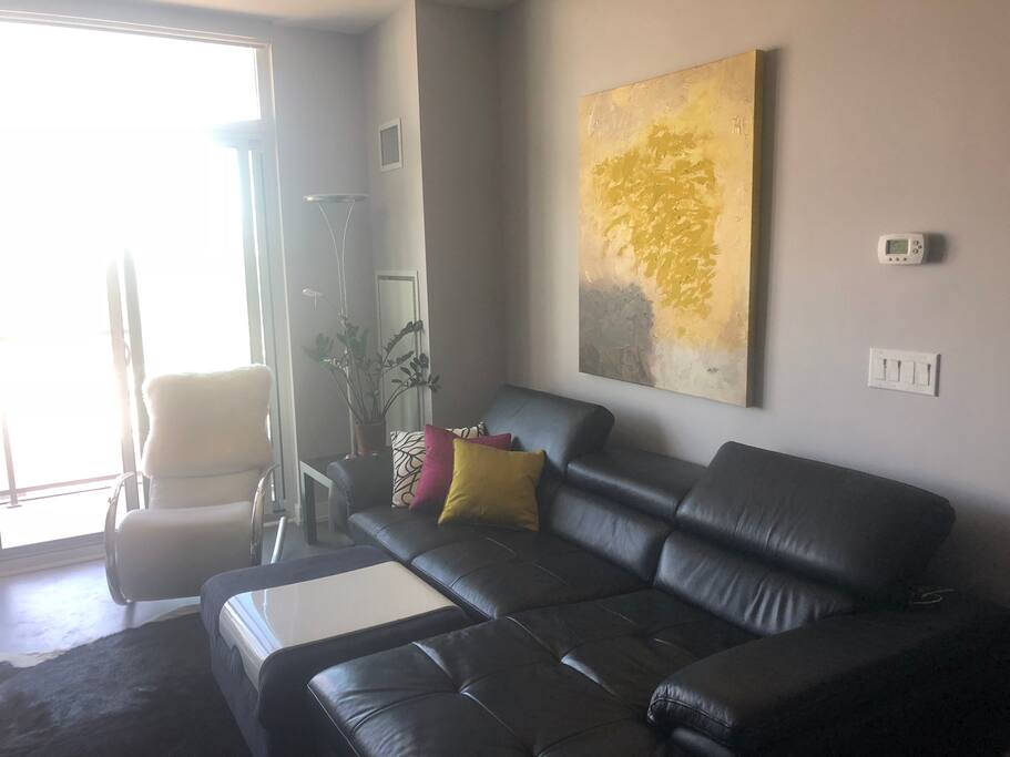 Bright, comfortable living room with oversized couch, 50” flat screen with Cable and Netflix. Hi speed internet.