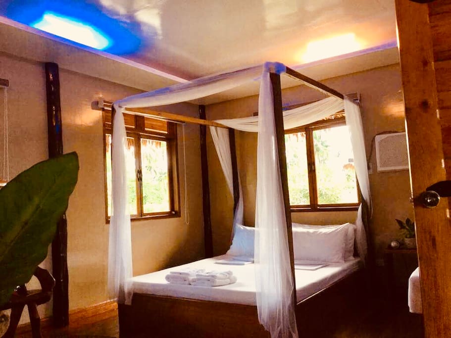 Inside the Room showing queen size bed and big windows with a view