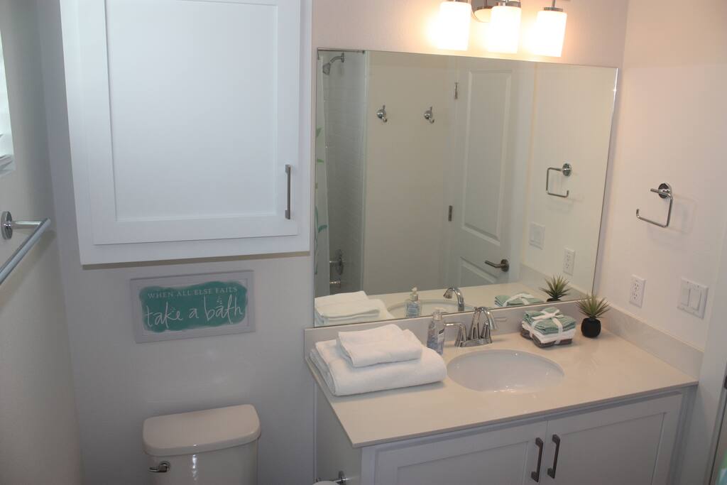 Clean, private bathroom stocked with shampoo and body wash.