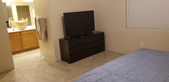 Televisor inteligente de 55 pulgadas con streaming Roku en el dormitorio principal.