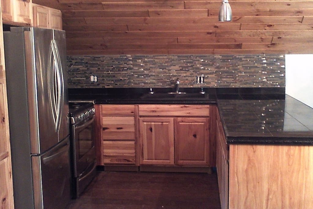 Kitchen with 5 burner gas range, French door fridge with ice maker