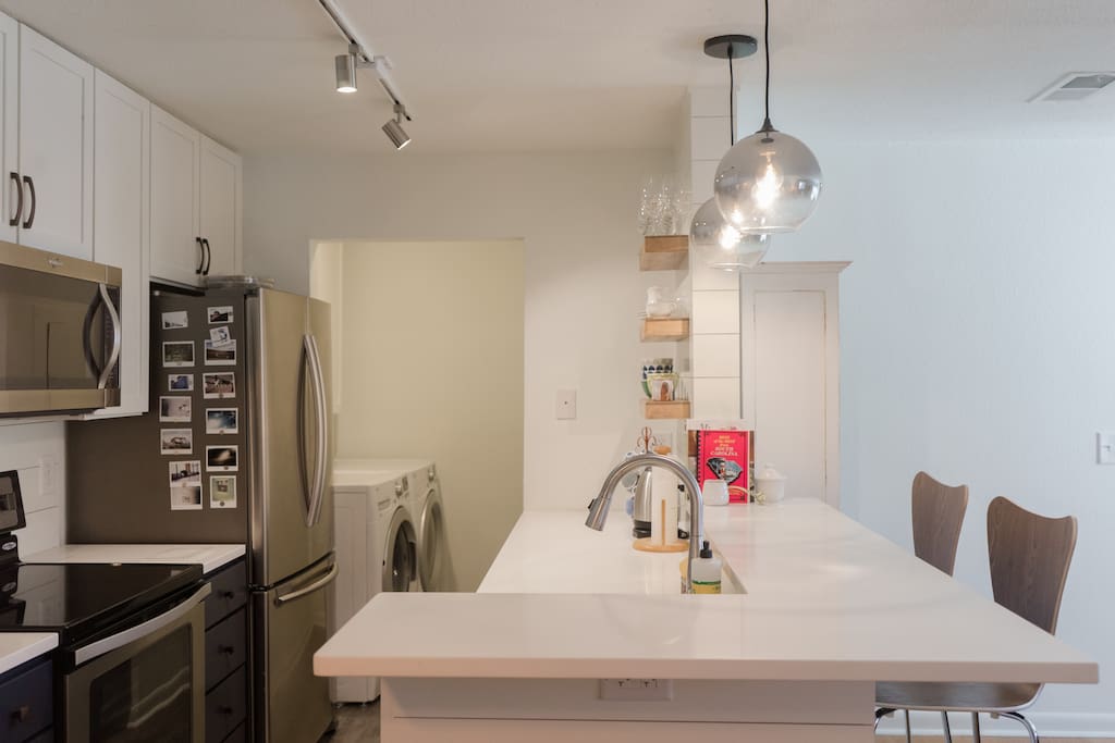 Kitchen is fully stocked for cooking, with dishwasher, washer-dryer, and new appliances.