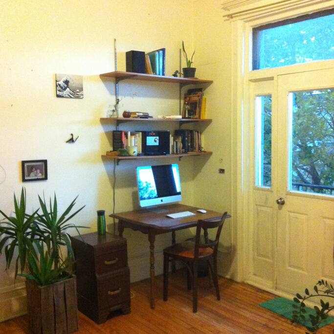 Nice old desk with lots of sunlight, and a CD player & docking station for music :)