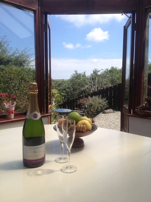 A great conservatory with patio doors and views across the hill towards Falmouth