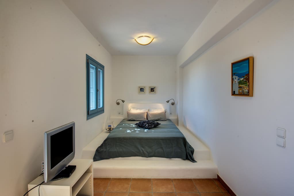 Bedroom with double bed and flat screen TV.