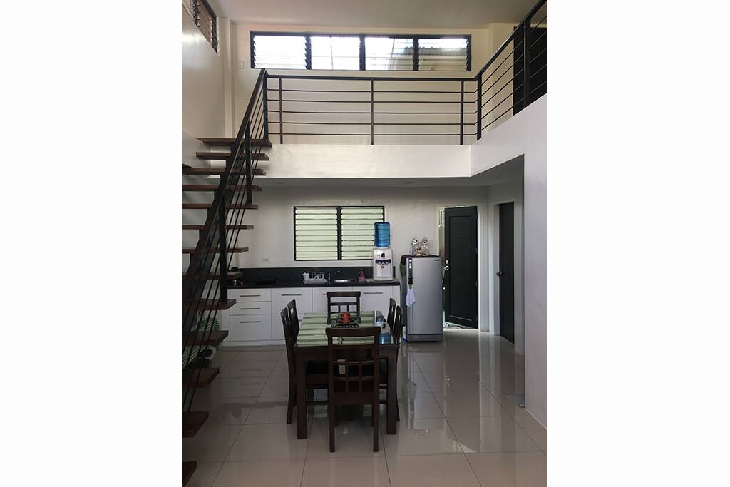 This is the stairs leading to the loft and the 6-seater dining table and small kitchen.