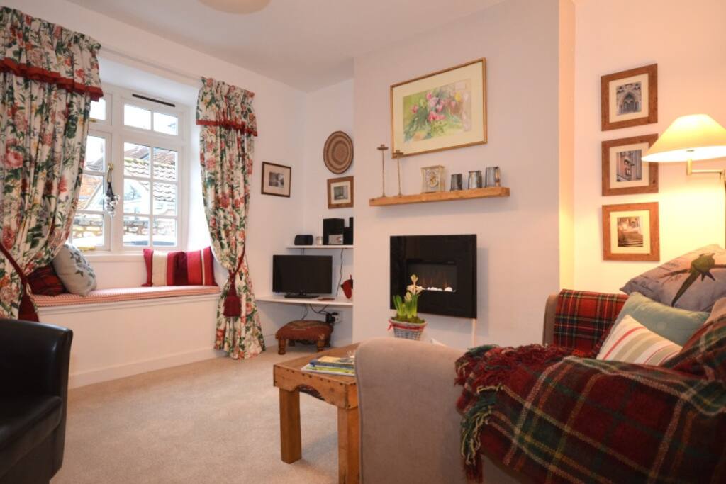 Beautiful sitting room with pebble fire & oak mantle, free WiFi, Sony CD/MP3/USB, comfy double sofa and tub armchair, designer curtains and deep window seat