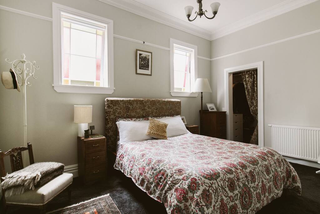 Master bedroom with walk in wardrobe. This room has beautiful light due to stained glass windows.