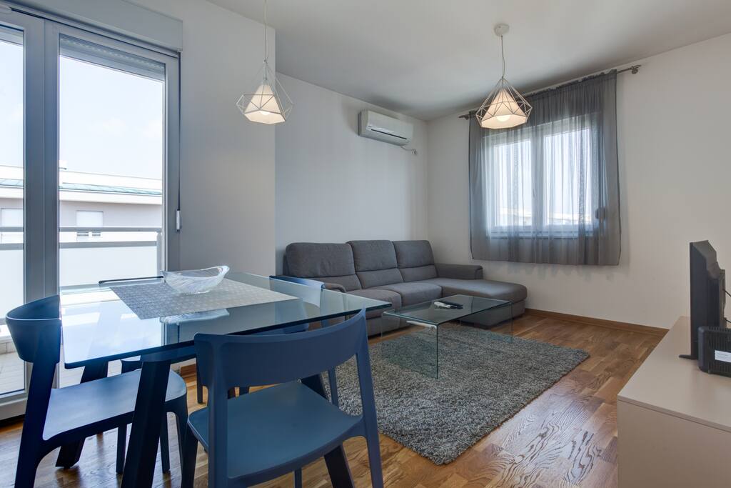 The living room includes a new corner set, a table and a TV with built-in cable television.