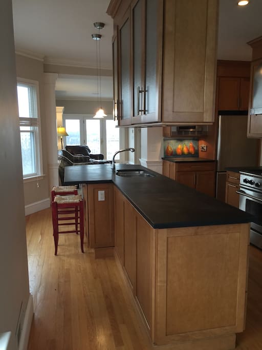 Kitchen with bar stools, expansive views of the city from all windows.