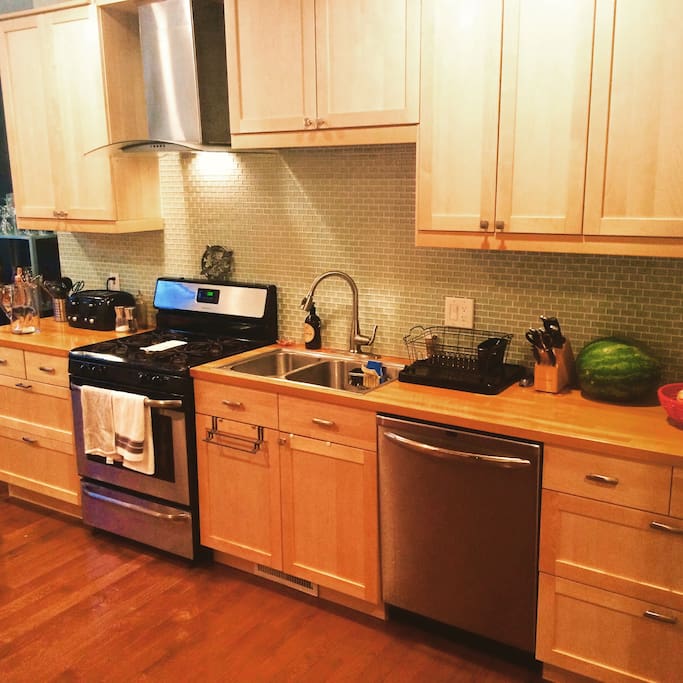 The kitchen is huge, with plenty of counter space and a new stainless steel gas range to prepare meals.