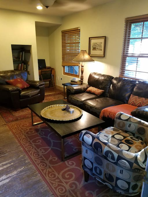 The living area has plenty of seating and features a desk and book/game nook.