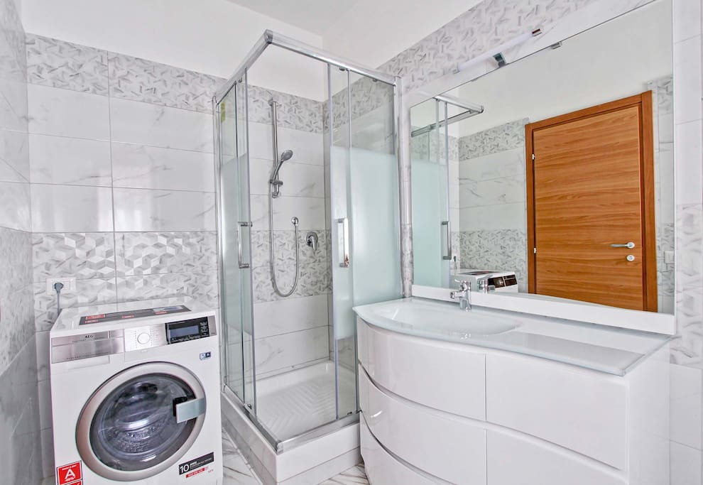 Bathroom with shower and washer/dryer