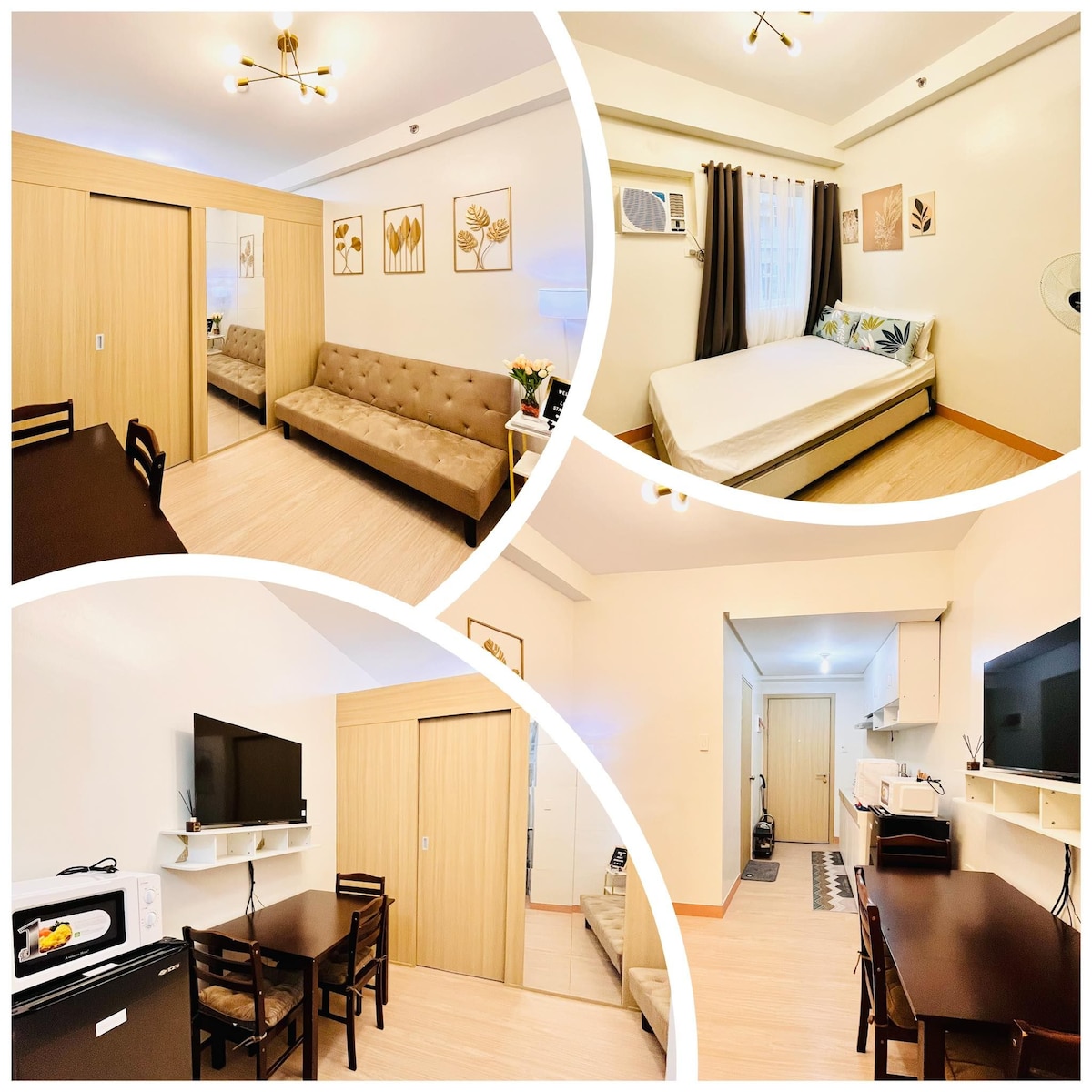A comfortable living area features a brown tufted sofa and a dining table with four chairs. A spacious bed is positioned against the wall, surrounded by decorative wall art. The kitchen area includes a microwave and a television mounted on the opposite wall.