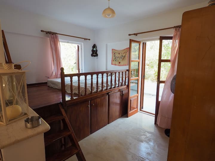 Traditional sofa with sea view overlooking the terrace, separated from the living room by a curtain
Traditional greek sofa with a sea view accessing a terrace, separated from the living room by curtains