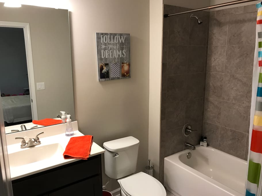 Private full bathroom with tile floors and shower.