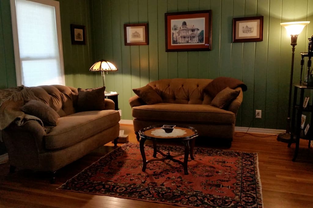 Living Room furnished with custom made love seats, antiques and original artwork