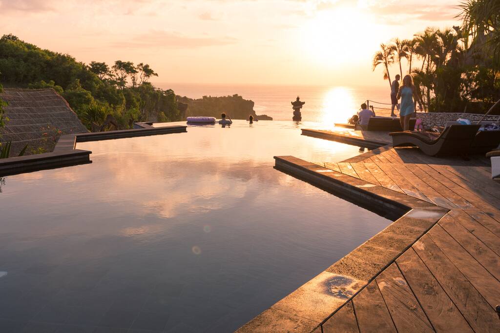 Three-tier honeycomb infinity pool during sunset. Hear the ocean waves below.