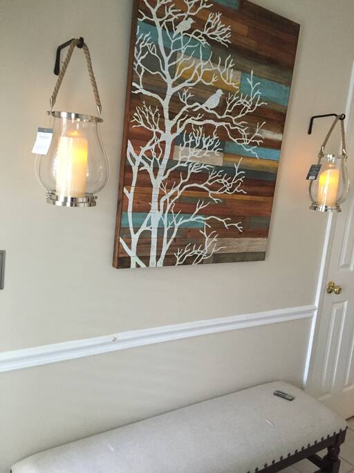 entryway complete with convenient place to sit take your shoes off and hang your belongings.