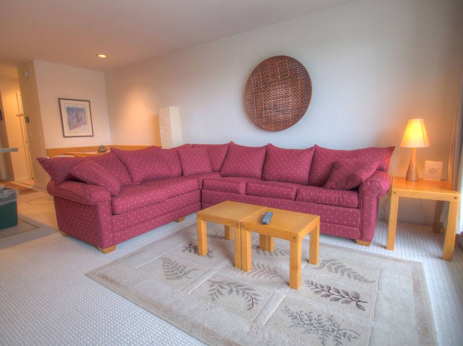 Living room area with large sectional couch - Large and comfortable couch features a pull-out bed.