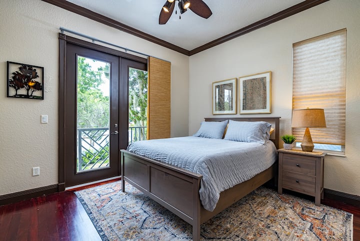 Third bedroom with a comfortable queen bed. Has a small private balcony overlooking the front yard.