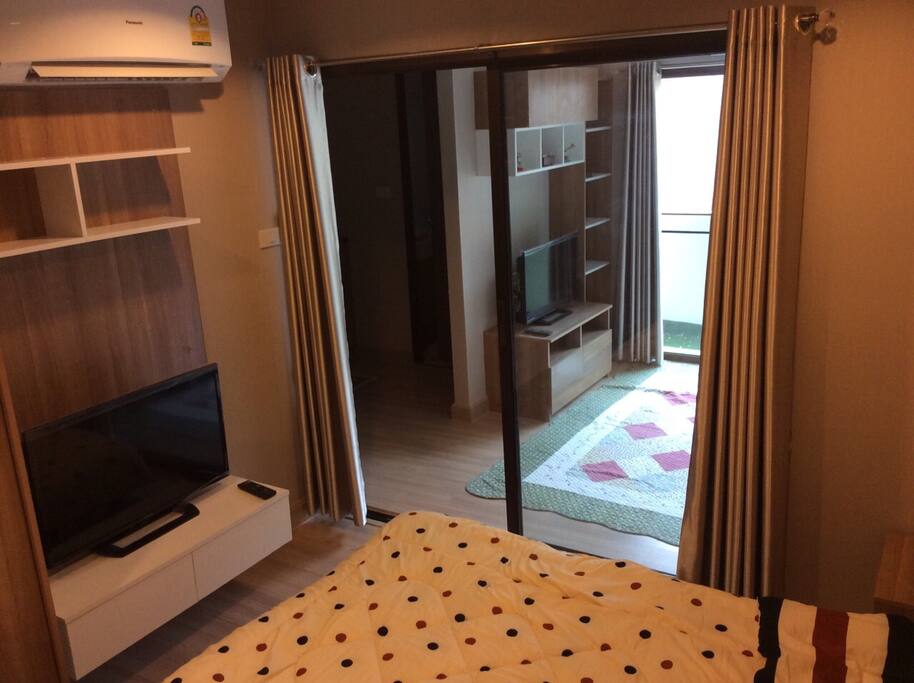 Clear partitioned bedroom with 32 inches television and 9,000 BTU air conditioner
