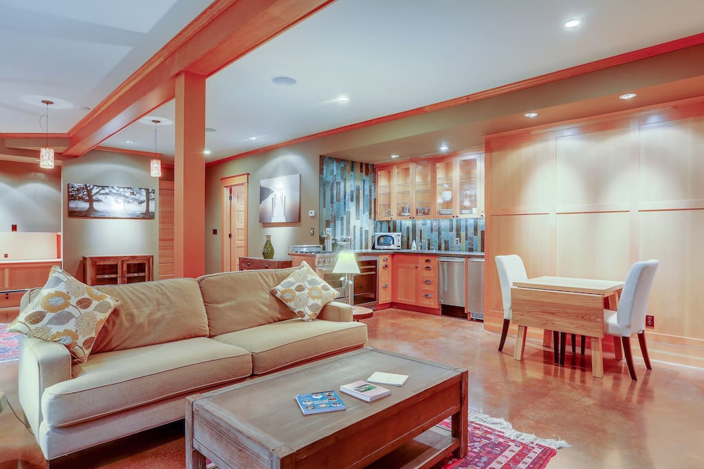 Large couch, lounge chair, coffee table and dining for two