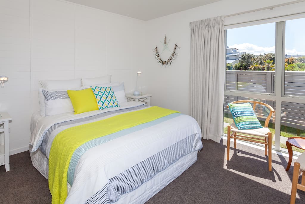 Halligan Room - big, queen sized bed and two chairs for relaxing