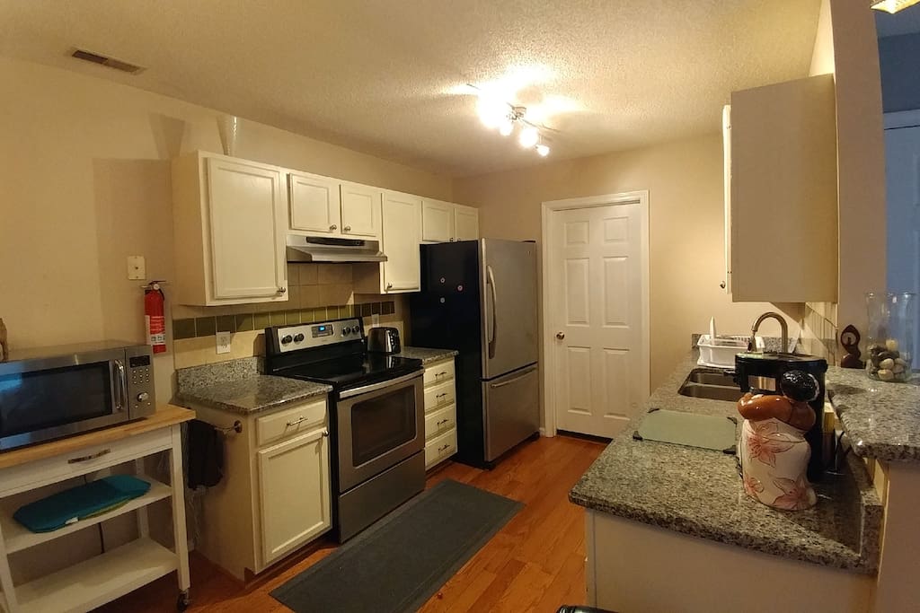 Guest access to microwave, range, refrigerator, dishes, dishwasher, coffee and tea bar. View also show entrance to laundry room.