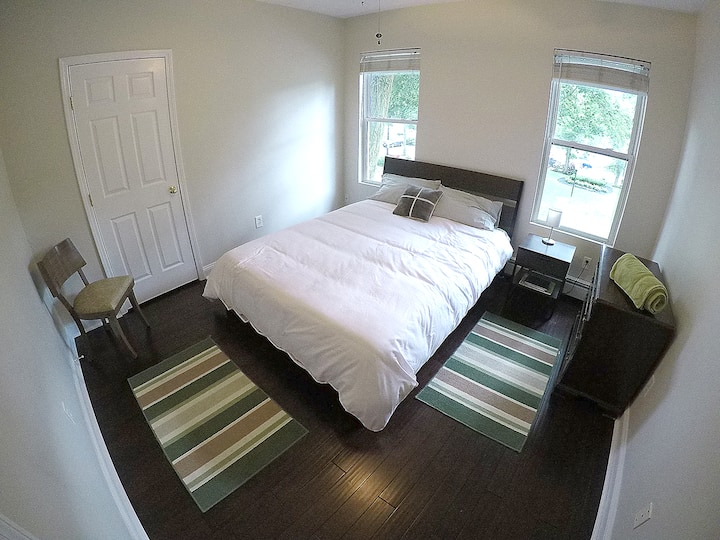 Bedroom #2. Queen bed, dresser, closet, chair, ceiling fan. 