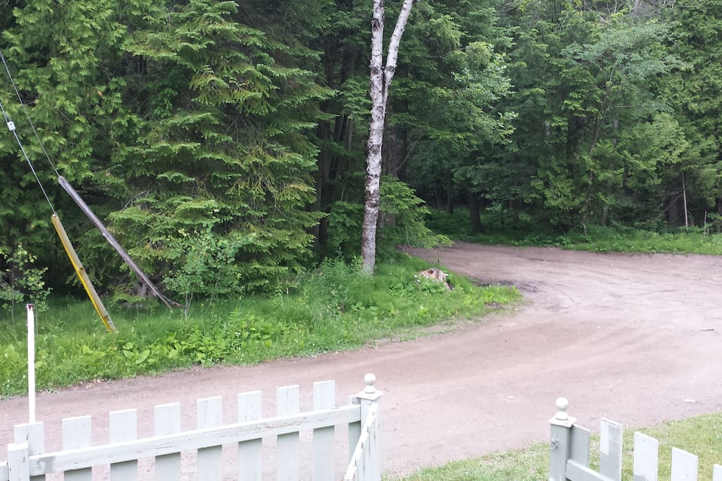 view from front porch, with fenced in front yard.