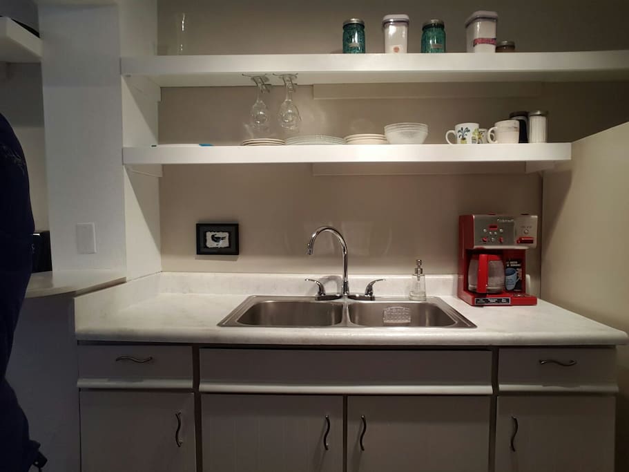 Kitchen features new shelving, counter top, sink faucet, and coffee maker. Help yourself to the complimentary coffee and breakfast fixings.