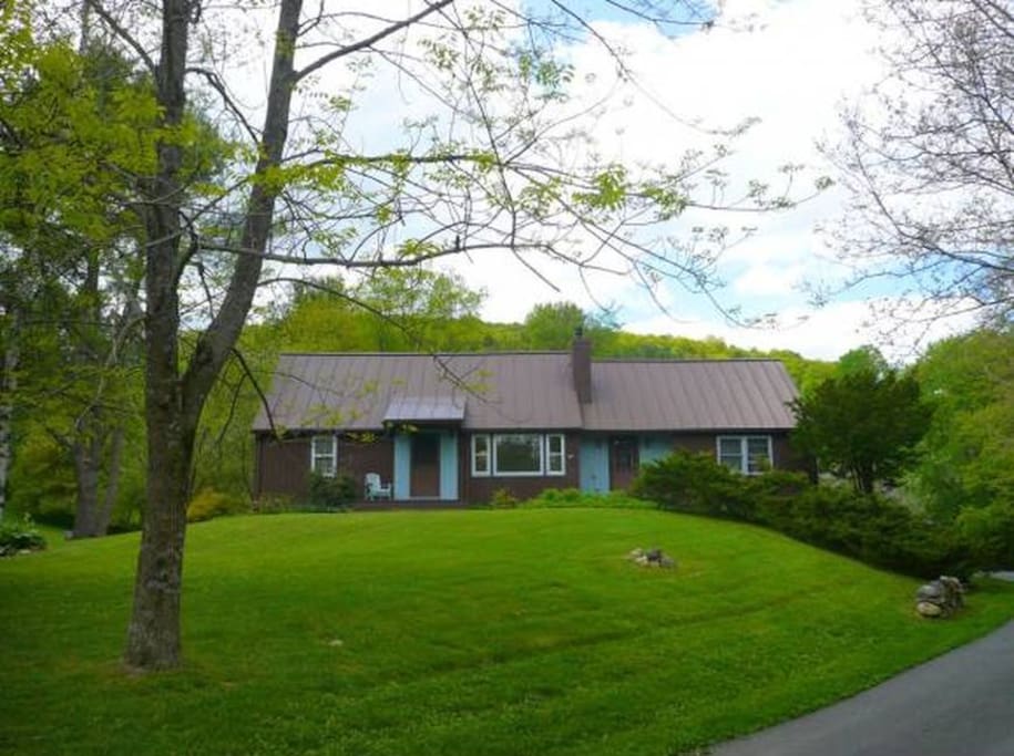 Extended cape set on an acre. Deck in back overlooks apple trees.