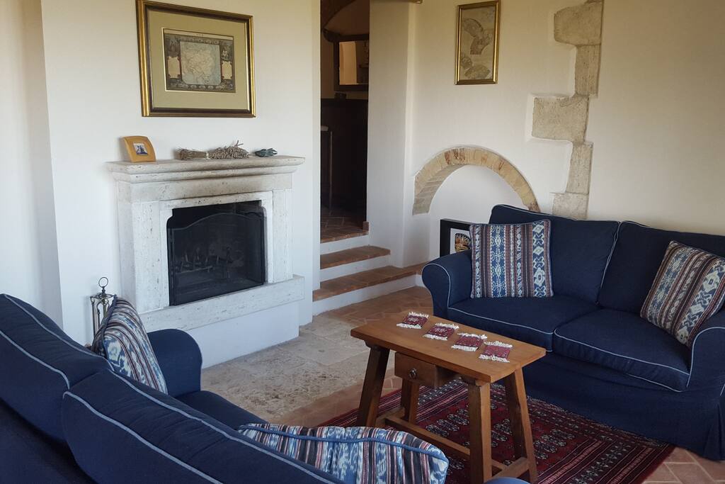 Downstairs living room with fireplace that opens to the yard.