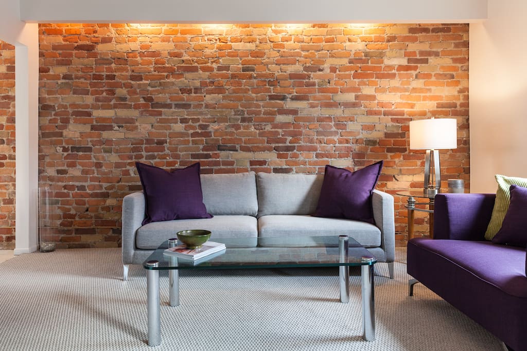 Exposed brick wall of living room.