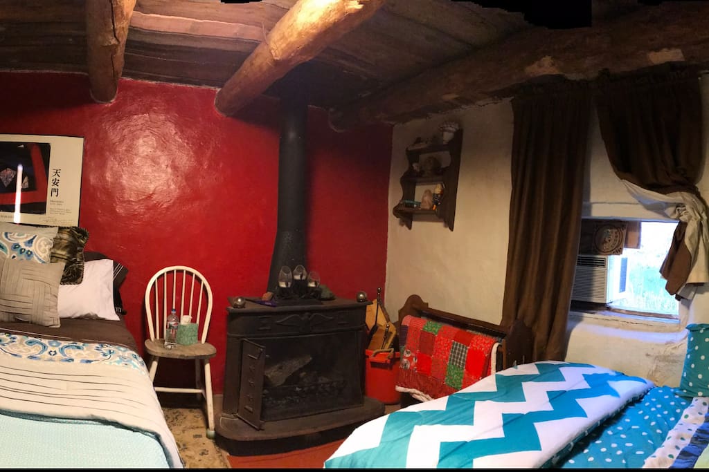 Queen and full bed in bedroom with fireplace