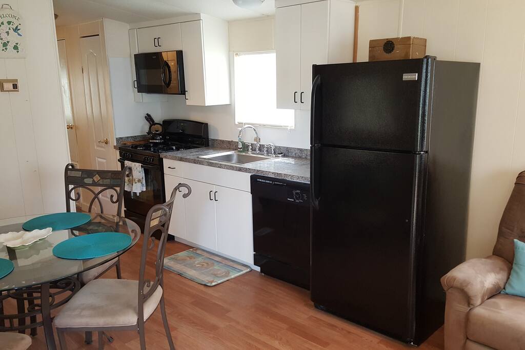 Newly remodeled kitchen with new cabinets, counter tops, sink and faucet and full size appliances.