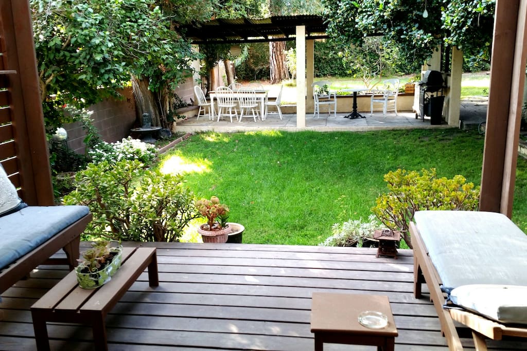 view of the large lush yard with patio