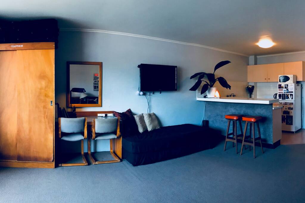 Additional bed and kitchen corner with bar-desk