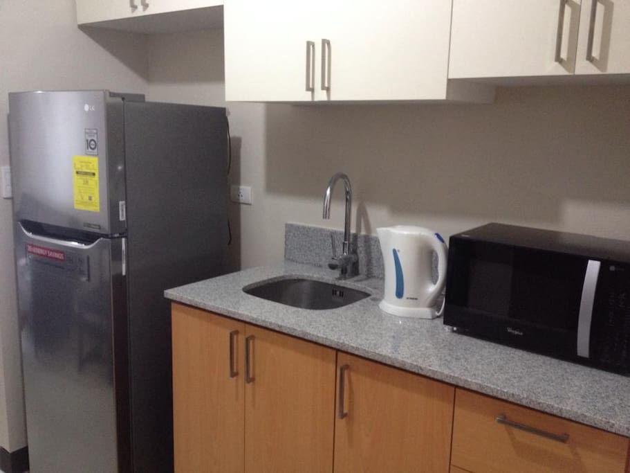 Kitchen complete with refrigerator, microwave and kettle