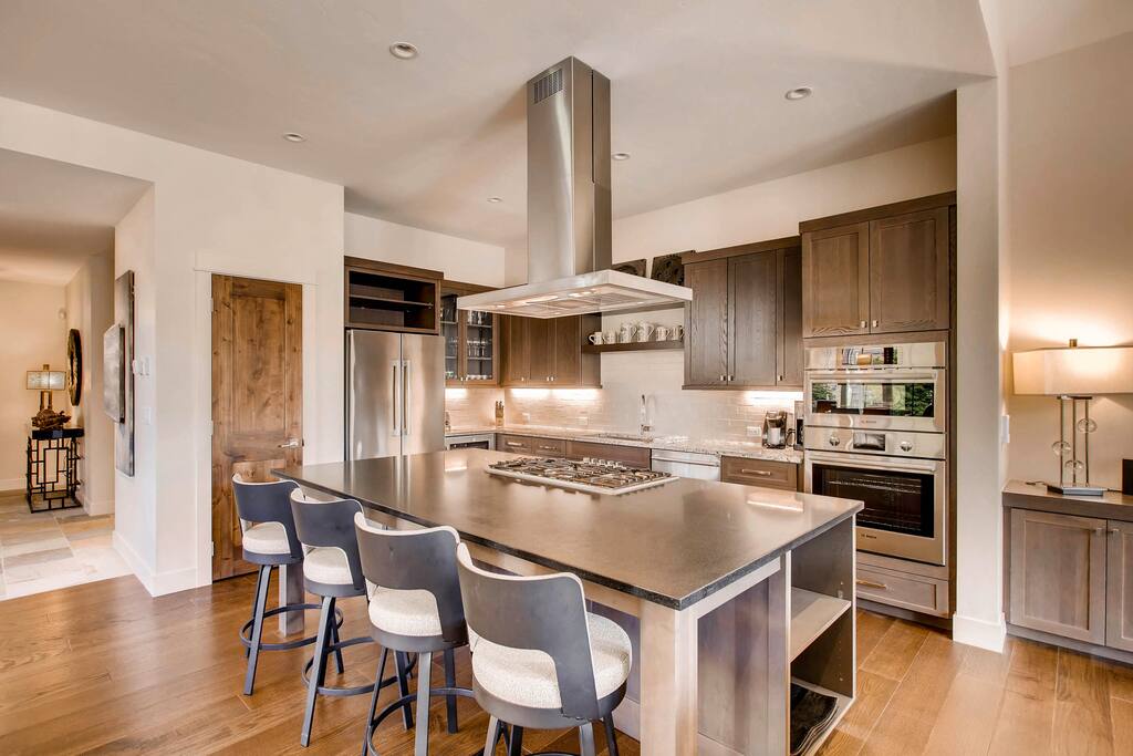 which opens to the living and dining area and also offers additional seating for dining