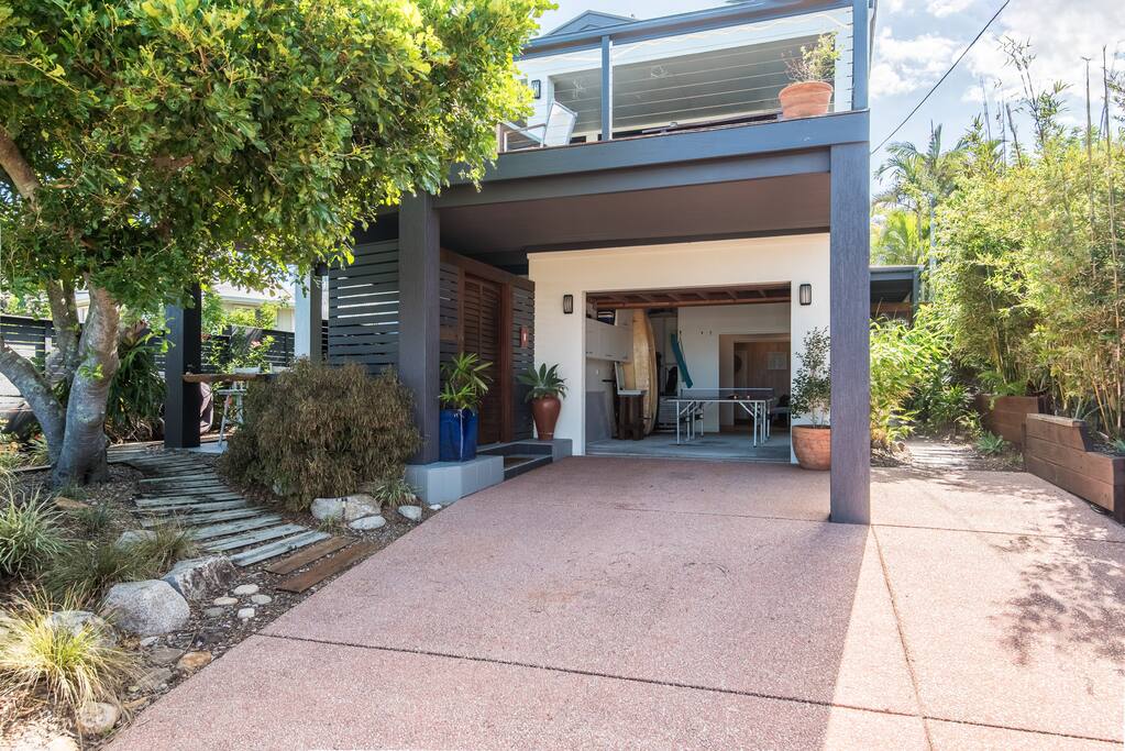 From the front of the house, looking into the garage with table tennis & surfboards.