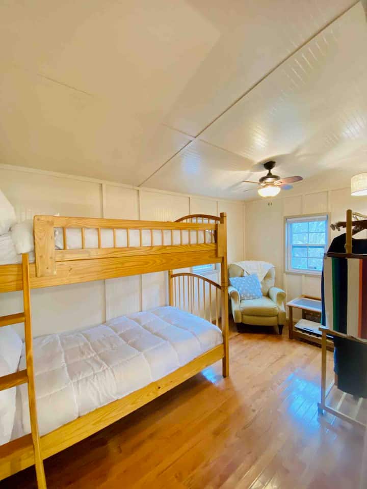 The downstairs bedroom with twin-sized bunk beds, and additional seating area/office space