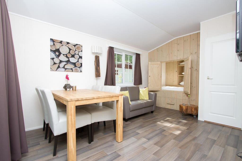 Woonkamer met TV, DVD-speler, eethoek en bedstede